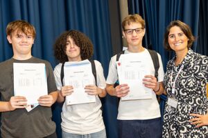 Haverstock GCSE students (L R) Lewis Keith, Isaac Djahlat and Liam Farmer with Head of School Katie Metselaar