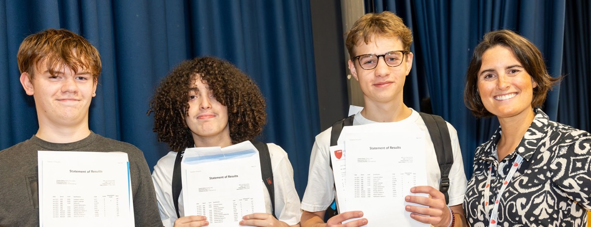 Haverstock GCSE students (L R) Lewis Keith, Isaac Djahlat and Liam Farmer with Head of School Katie Metselaar